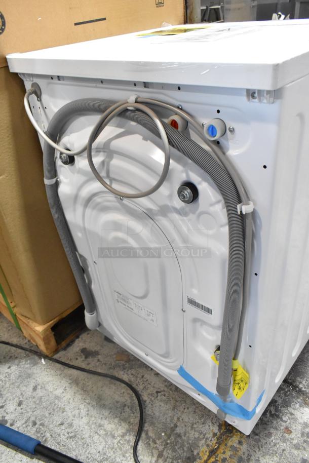 Brand new 2023 KoolMore FLW-3CWH 2.7 cu. ft. stackable washing machine, 120 volts. Visible hose connections, minor scratches.
