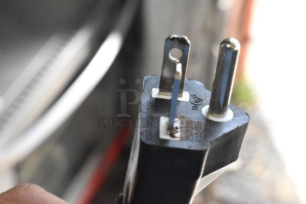 Close-up of the plug for a 2023 Avantco 177IC35SU Stainless Steel Induction Range, showing prongs and voltage markings.