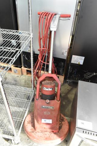 Clarke Burnisher 1500DCR floor cleaning machine, 115 volts, 1 phase, used condition, visible scuffs, red finish, model label intact.