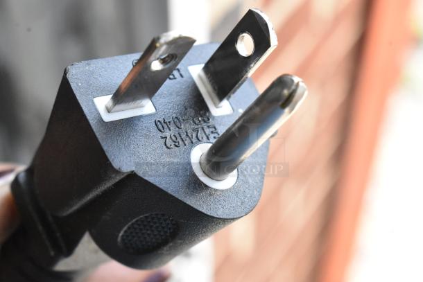 Close-up of a three-prong plug for the Avantco 177CO28M convection oven, showing voltage details embossed on the plug.