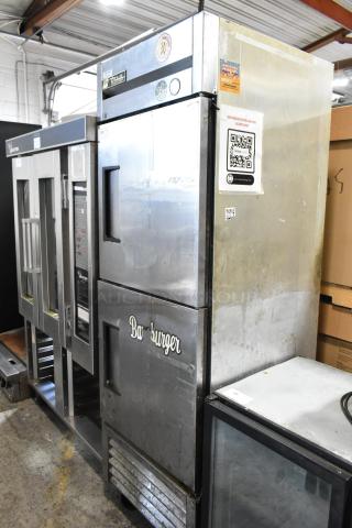 True T-23F-2 stainless steel commercial freezer with two half-size doors, commercial casters, and visible branding.