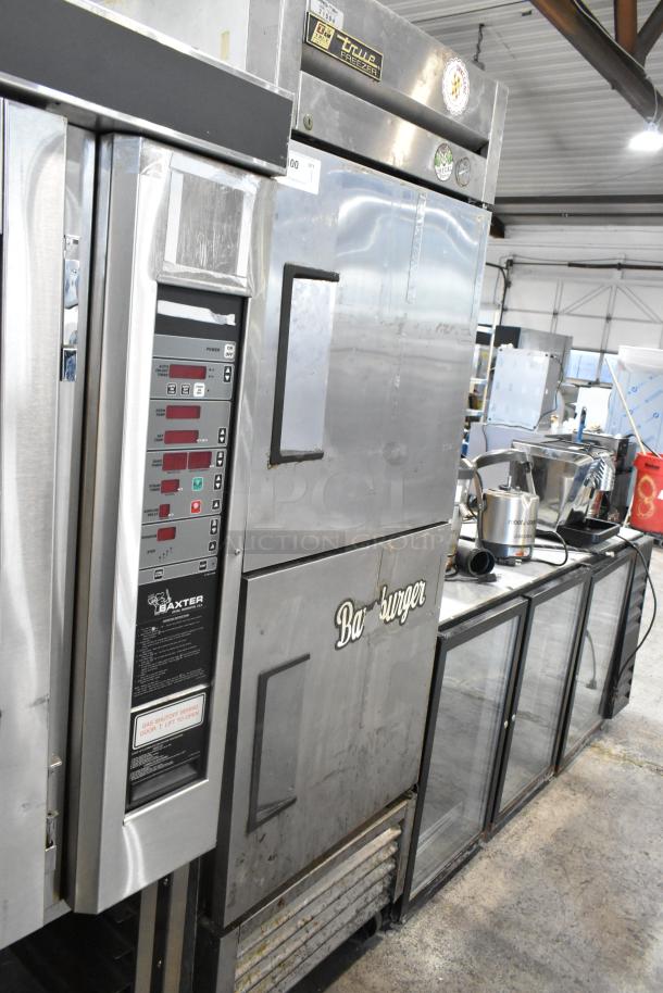 True T-23F-2 stainless steel commercial freezer with two half-size doors, on casters. Features control panel and branding.