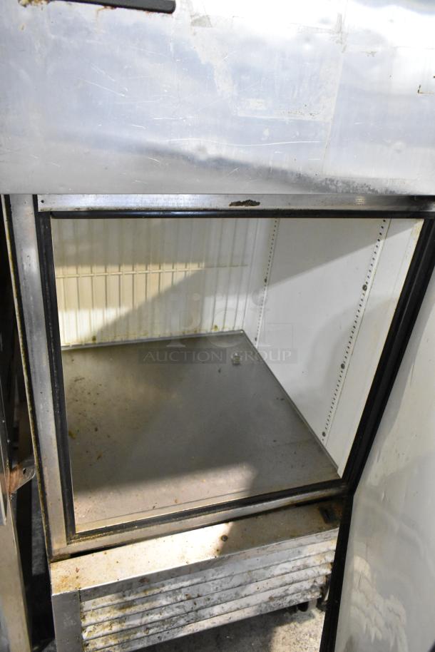 True T-23F-2 stainless steel commercial reach-in freezer, two half-size doors, on casters, interior view, used condition.