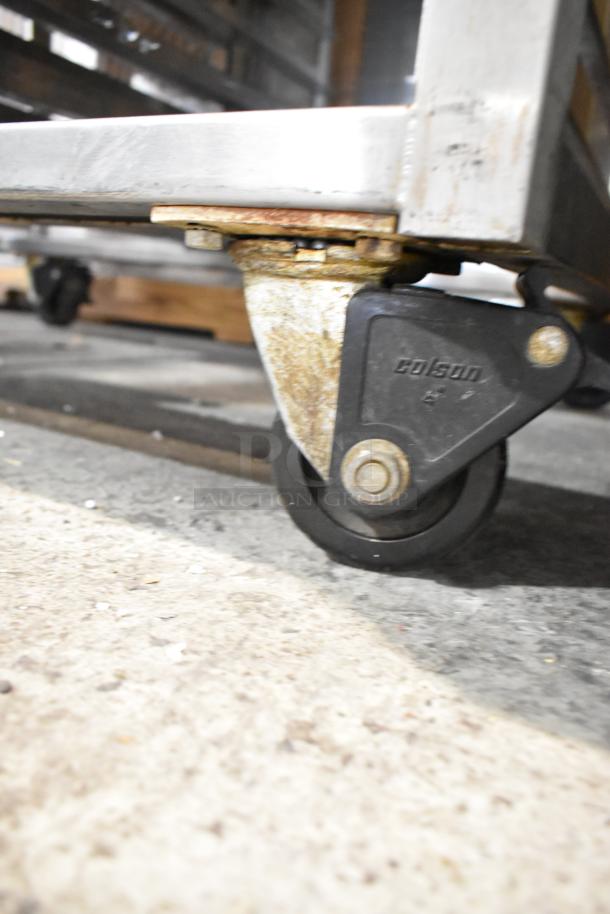 Baxter stainless steel commercial rack oven caster, featuring Colson-branded wheel; part of mini rotating rack oven setup.