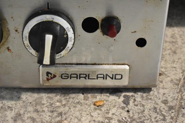 Garland stainless steel commercial gas flat top griddle, showing control knob and Garland logo. Used condition.