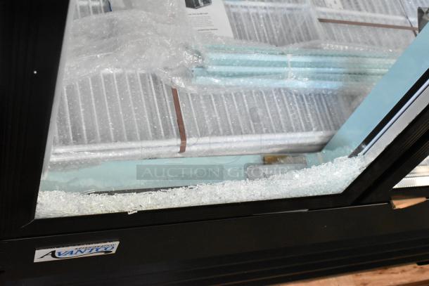 Brand new Avantco 178GDC40HCB merchandiser fridge with broken glass door, LED lighting visible, wrapped shelving inside.
