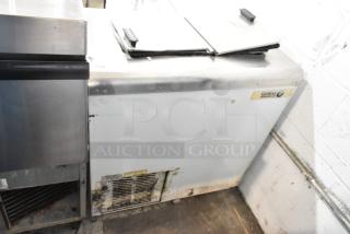 Globe metal chest freezer, 115 volts, 1 phase, with visible wear and markings. Label indicates "Globe" brand.