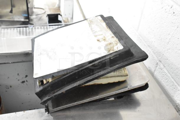 Globe Metal Chest Freezer lid shown. Visible wear and tear. 115 Volts, 1 Phase. Auction item for potential restoration.