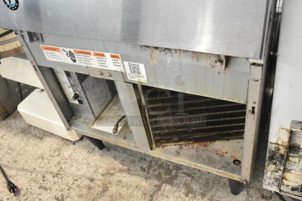 Hoshizaki F-330BAJ stainless steel undercounter ice machine, showing visible wear. 115 volts, 1 phase, with safety warning labels.