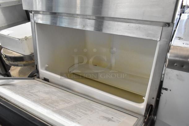 Hoshizaki F-330BAJ stainless steel undercounter ice machine, open ice compartment, showing clean interior, 115V, 1 phase.