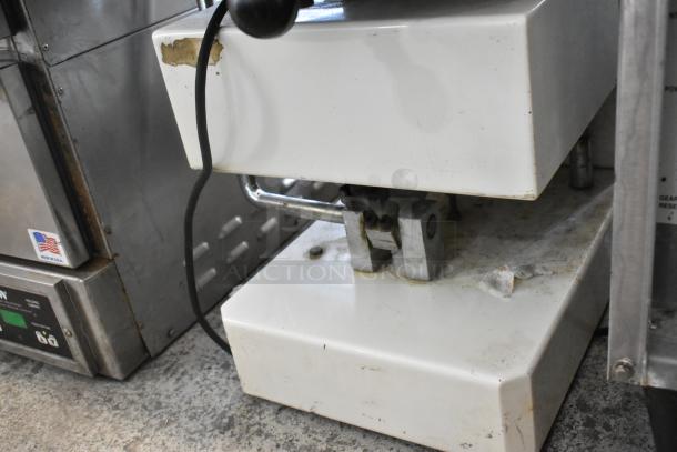 Spizza Metal Commercial Countertop Dough Press, 220 Volts, 1 Phase. Shows signs of wear, used condition. Model: Spizza.