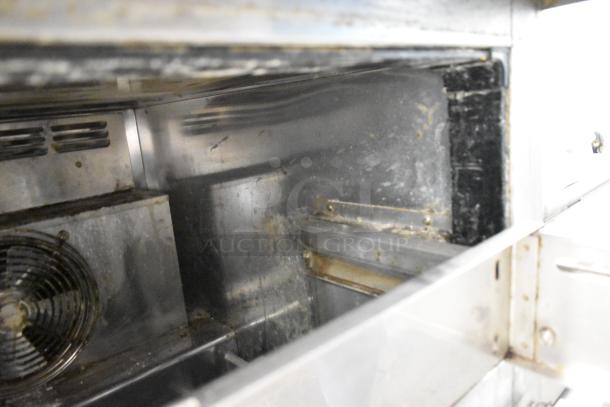 Everest stainless steel commercial 2-drawer undercounter cooler interior, showing shelving and fan; used condition.