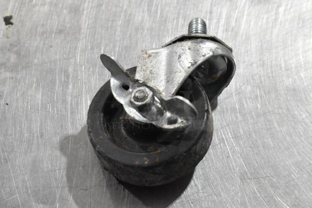 Close-up of a metal caster wheel with a rubber tire, showing slight wear. Used for Alto Shaam 750-CTUS holding cabinet.
