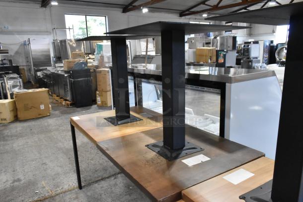 6 wooden tables with black metal legs, varied wooden finishes, in good condition, visible labels indicating item specs.