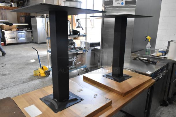 Six wooden tables with metal legs, industrial style, in varied condition. Ideal for bidding, includes visible wear marks.