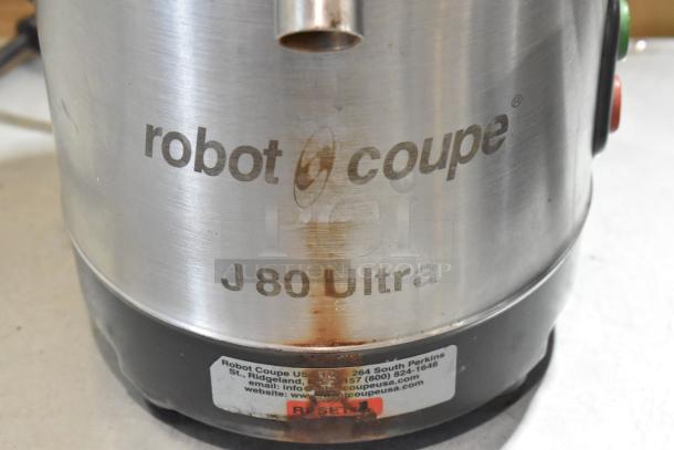 Set of 2 Robot Coupe J 80 Ultra juicers; one missing top. Stainless steel, 120V, single-phase. Visible wear and label with contact details.