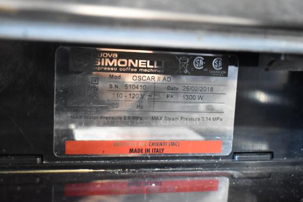 Nuova Simonelli Oscar II AD espresso machine label showing model, serial number, voltage, and "Made in Italy" marking.