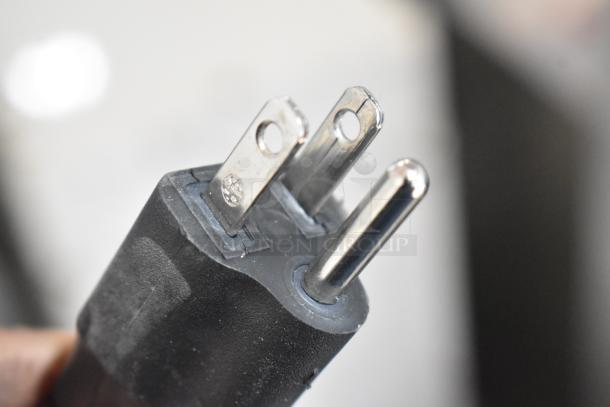 Close-up of a black three-prong plug from a 2025 Berkel B12-SLC meat slicer. 115 Volts, 1 Phase.