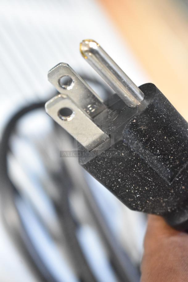 Close-up of a three-prong plug for the Avantco 178DLC82HCW deli case, highlighting its electrical connection point.
