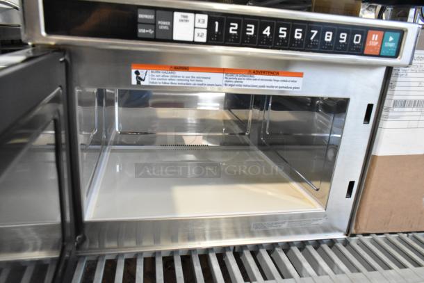 Brand new Solwave stainless steel commercial countertop microwave oven, visible numeric keypad, interior stainless steel finish.