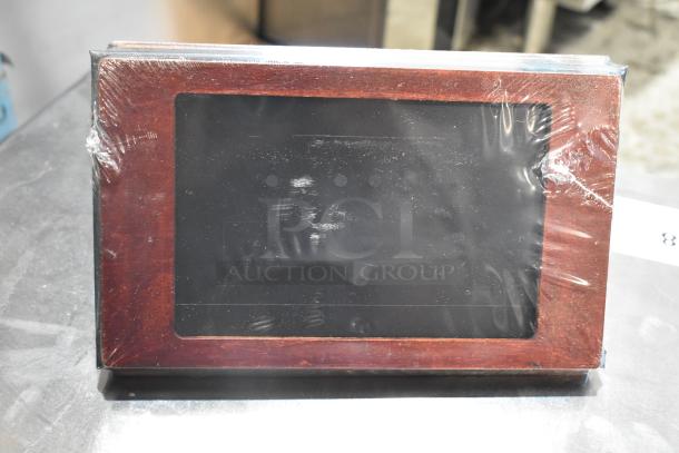 Box of Menu Solutions wooden countertop menu holders, new, scratch and dent condition, wrapped in protective plastic.