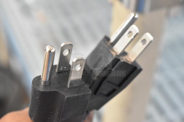 Close-up of a standard three-prong plug for the Carnival King 382WBM26DGT waffle maker.