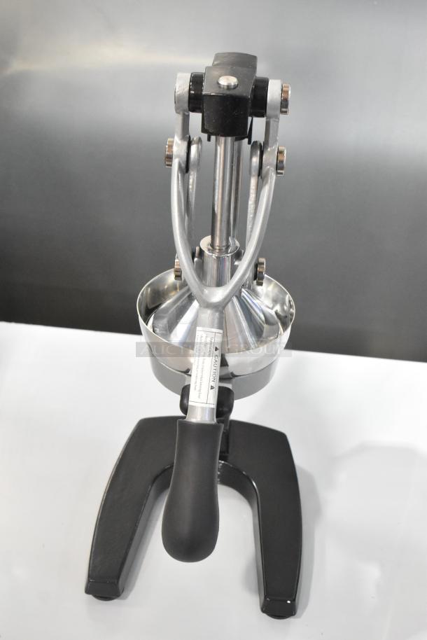 BRAND NEW Garde 5015567 Metal Manual Citrus Juicer, scratch and dent, sturdy metal, ergonomic handle, caution label visible.