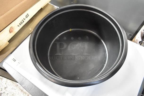 BRAND NEW metal rice cooker insert, black, slight scratches visible. Includes matching lid. Ideal for replacement.