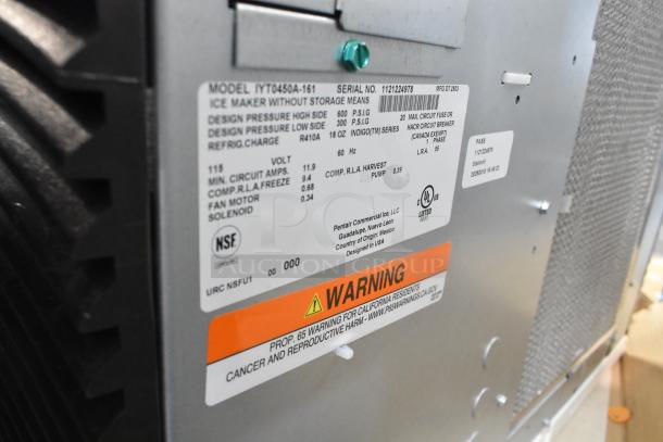 Stainless steel Manitowoc 194MCF430A ice machine, model IYT0450A-161. Includes labels and warning tag. 490 lb capacity.