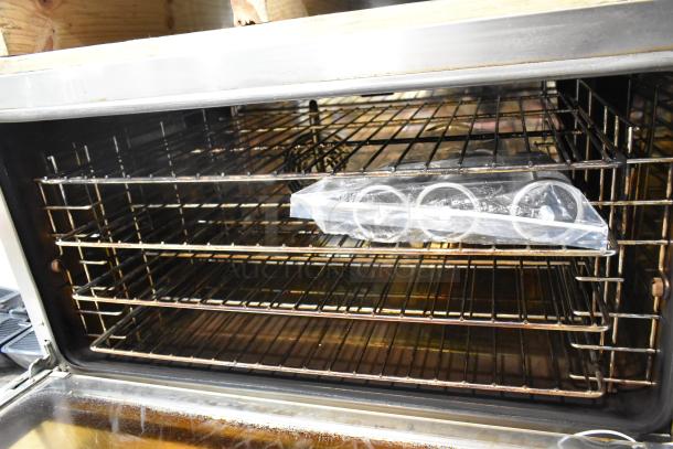 BRAND NEW SCRATCH AND DENT! Cooking Performance Group 351COFT4M electric convection oven, 4 trays, stainless steel interior.