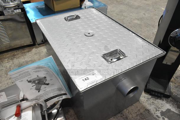 Brand new Regency 600GT25 50 lb. 25 GPM grease trap with 3" non-threaded connections, minor scratches, and dents visible.