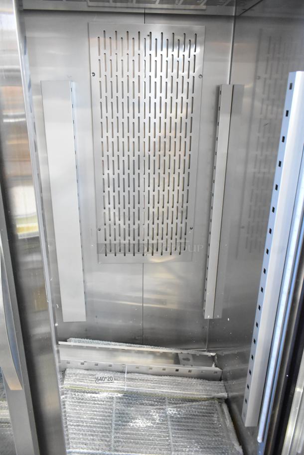 Stainless steel interior of a 2025 Avantco 178Z2RGHC commercial 2-door reach-in cooler with poly coated racks, new condition.