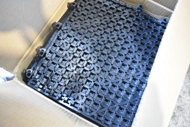 Box of Choice 12" x 12" Black Interlocking Bar Mats, new condition, detailed grid pattern visible.