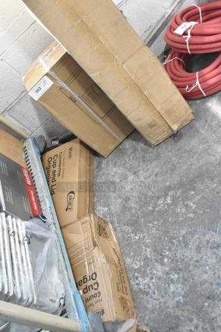 Four brand new items in boxes: ServIt 72" strip warmer, 360 Office key cabinet, cup and lid organizer, coiled red hoses.