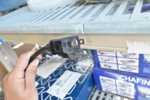 Alt text: Close-up of a power plug for a new Avantco 177W50 stainless steel electric food warmer, 120 volts, 1 phase.
