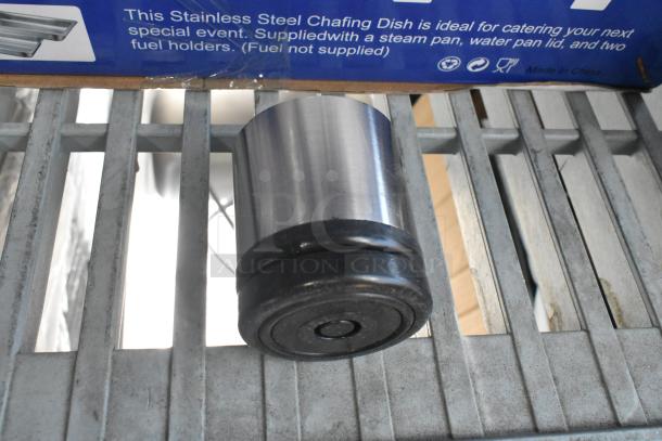Box of 4 metal legs, brand new with minor scratches and dents, stainless steel, suitable for furniture or appliances.