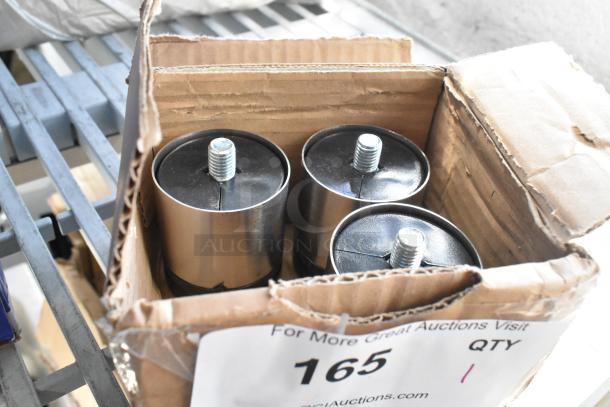 Box of 4 brand new metal legs, minor scratches and dents, threaded tops, in original packaging, auction label visible.