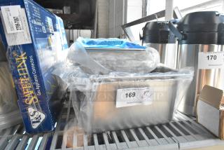 Three brand new items: stainless steel drop-in bins and metal baking pan, boxed. Items marked "169," auction details visible.