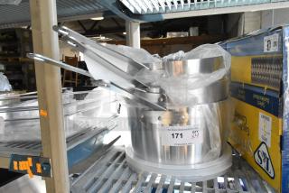 Four brand new scratch and dent aluminum sauce pans, including Choice 10 Qt. and 7 Qt. models, labeled for auction.