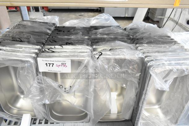 55 brand new scratch and dent stainless steel drop-in bins, packed in plastic, labeled "177, Qty 55" from PCI Auctions.