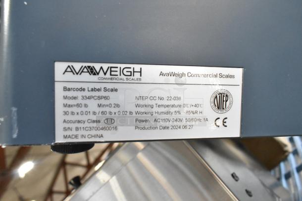 BRAND NEW SCRATCH AND DENT 2024 AvaWeigh 334PCSP60 scale label showing model, specs, and production info; 60 lb capacity.
