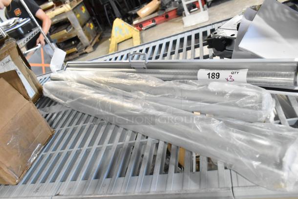 Three brand new scratch and dent pull-down screens for merchandiser. Labeled "189 QTY x3." Still in protective packaging.
