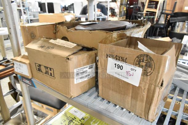 Boxes of scratch and dent items, including Avantco thermopile and Front of the House porcelain bowls, on a metal shelf.