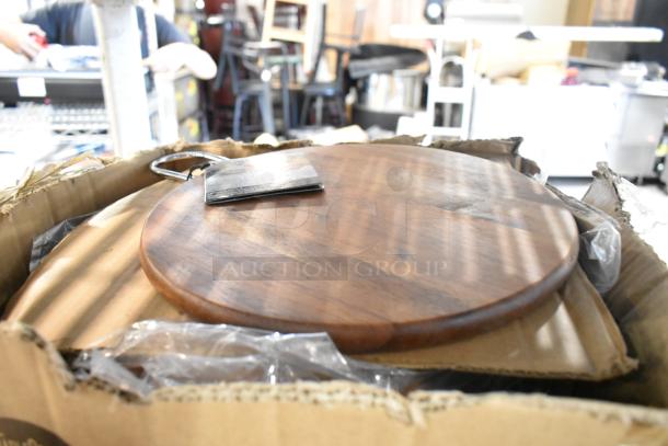 Scratch and dent auction items in a box, featuring a wooden Tablecraft Acacia Round Display Board.