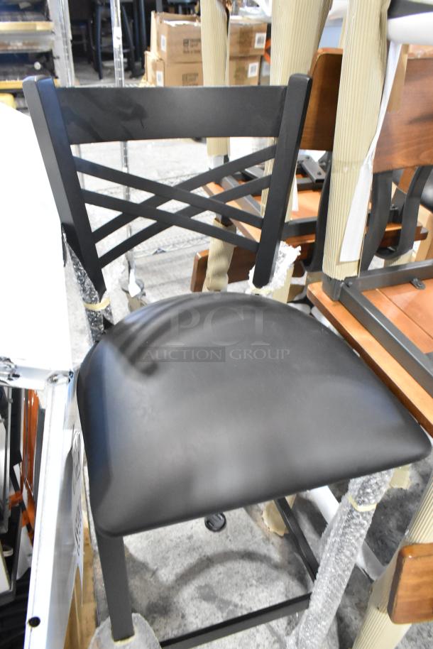 Brand new black bar-height chair with cross-back design, minor scratches, padded seat, available in set of seven.
