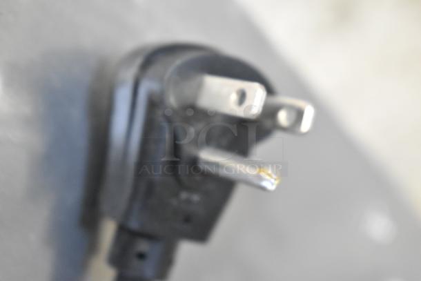 Close-up of a power plug for the Scotsman HID525AB-1A ice machine, showing slight wear.