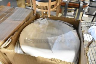 Four new boxes of assorted white ceramic dishes in partially opened packaging; some items labeled "scratch and dent."