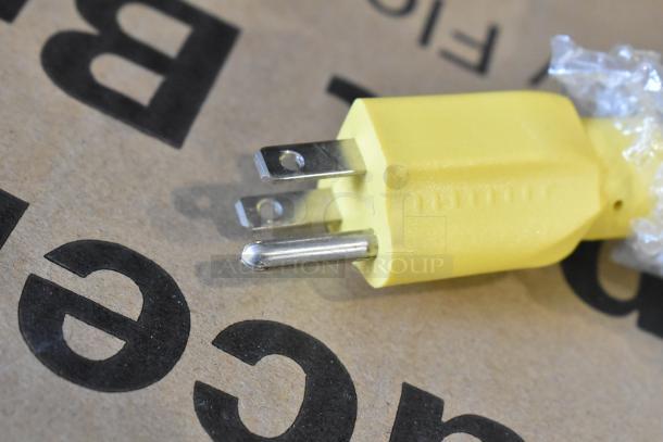 Close-up of a power plug for a Lavex 978LAVP20A rotary floor machine. Yellow plug with three prongs.