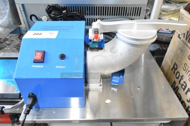 Brand new commercial countertop ice shaver, metal, 120 volts, 1 phase. Scratch and dent condition. Power and reset buttons visible.