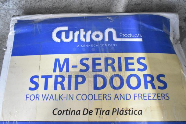 2 Curtron M Series Strip Doors in original packaging for walk-in coolers. Slight box wear visible.